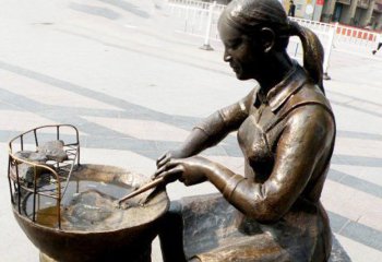 梨雕塑-步行街烤梨人物铜雕梨雕塑