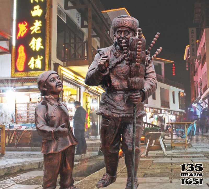 糖葫芦雕塑-民宿文化街边摆放卖糖葫芦的人物铜雕高清图片