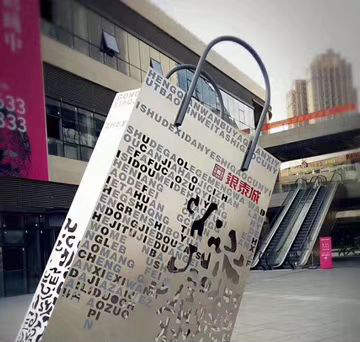 购物袋雕塑-不锈钢镂空创意城市街道购物袋雕塑高清图片