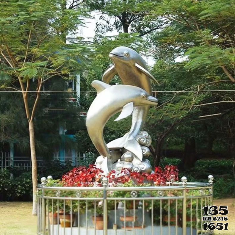 海豚雕塑-花园从中两只不锈钢海豚雕塑高清图片