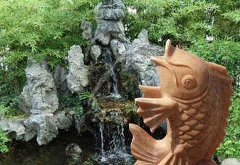 鲤鱼雕塑-公园里摆放的黄蜡石石雕创意鲤鱼雕塑